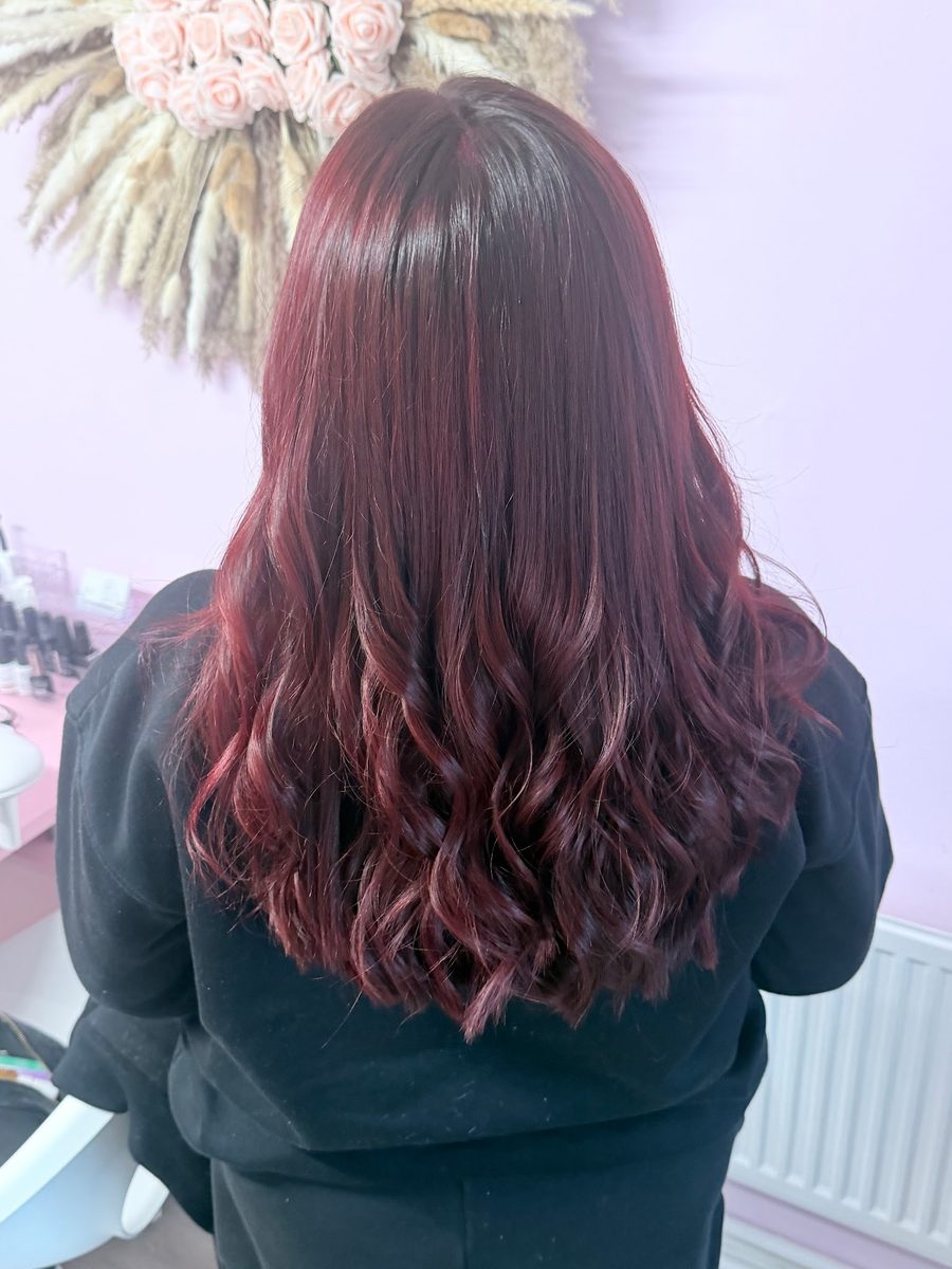 Deep cherry-red full head colour with soft waves
